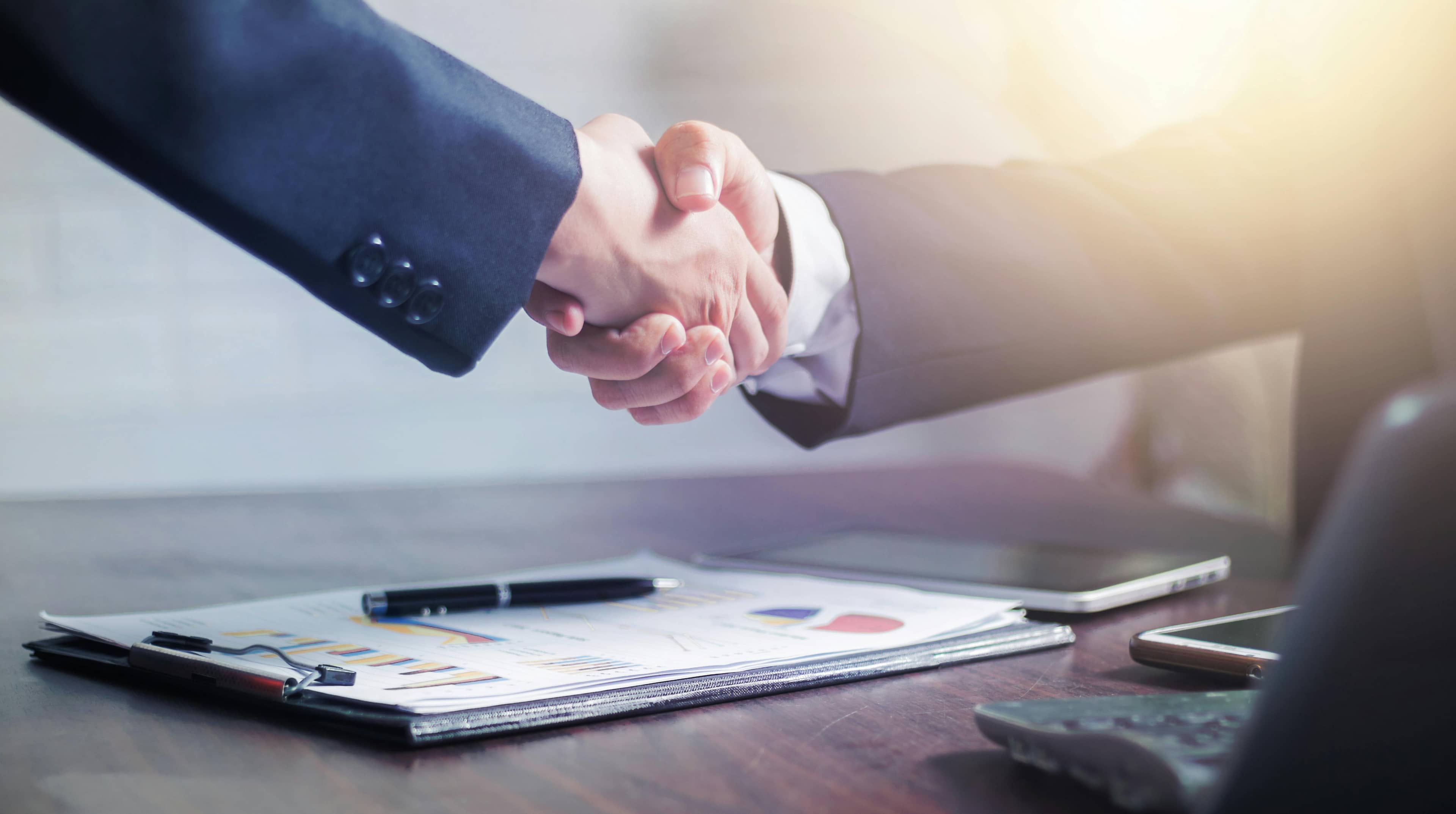 Business handshake representing general liability insurance