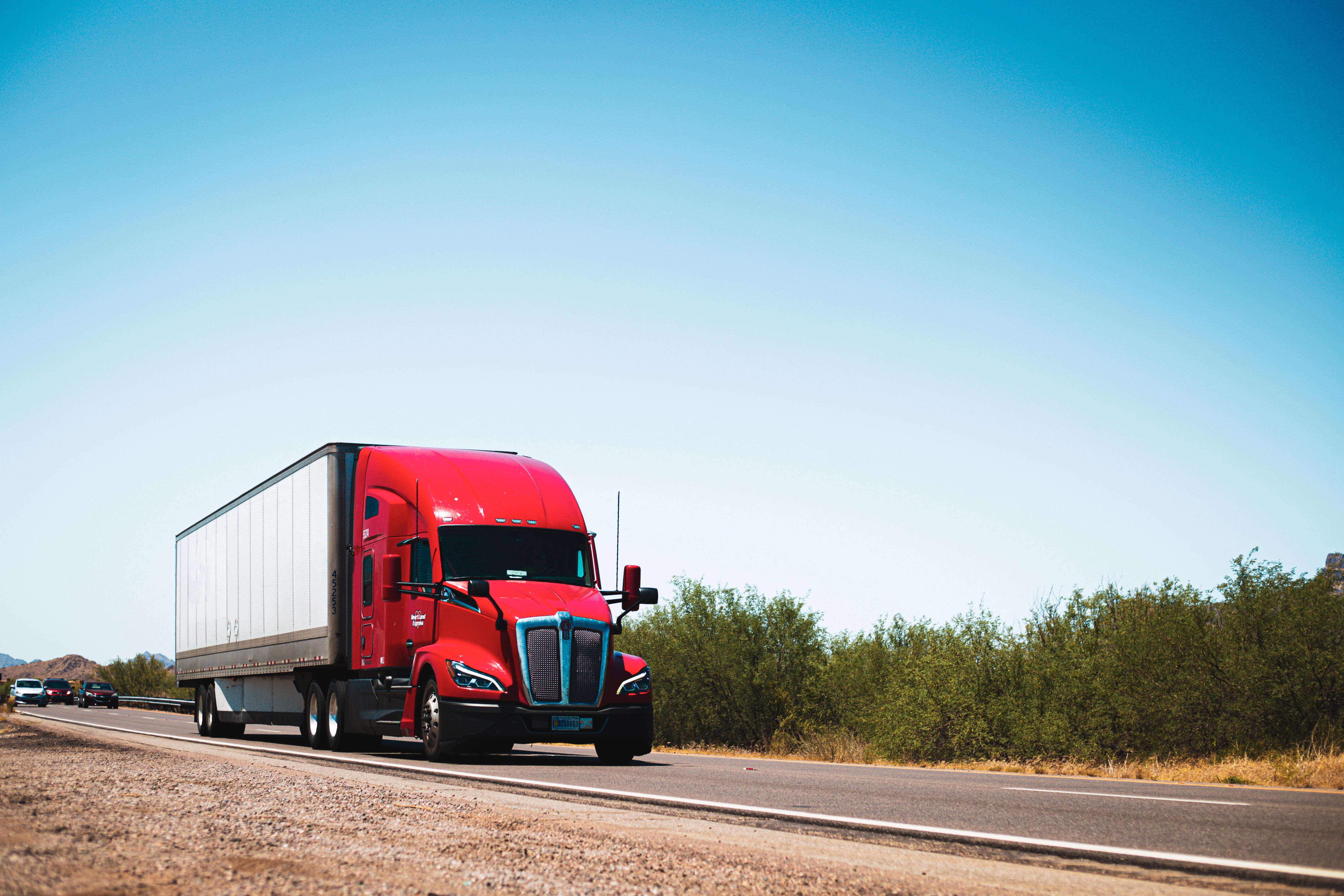 Illustration of a commercial truck and shield for Pennsylvania trucking insurance coverage