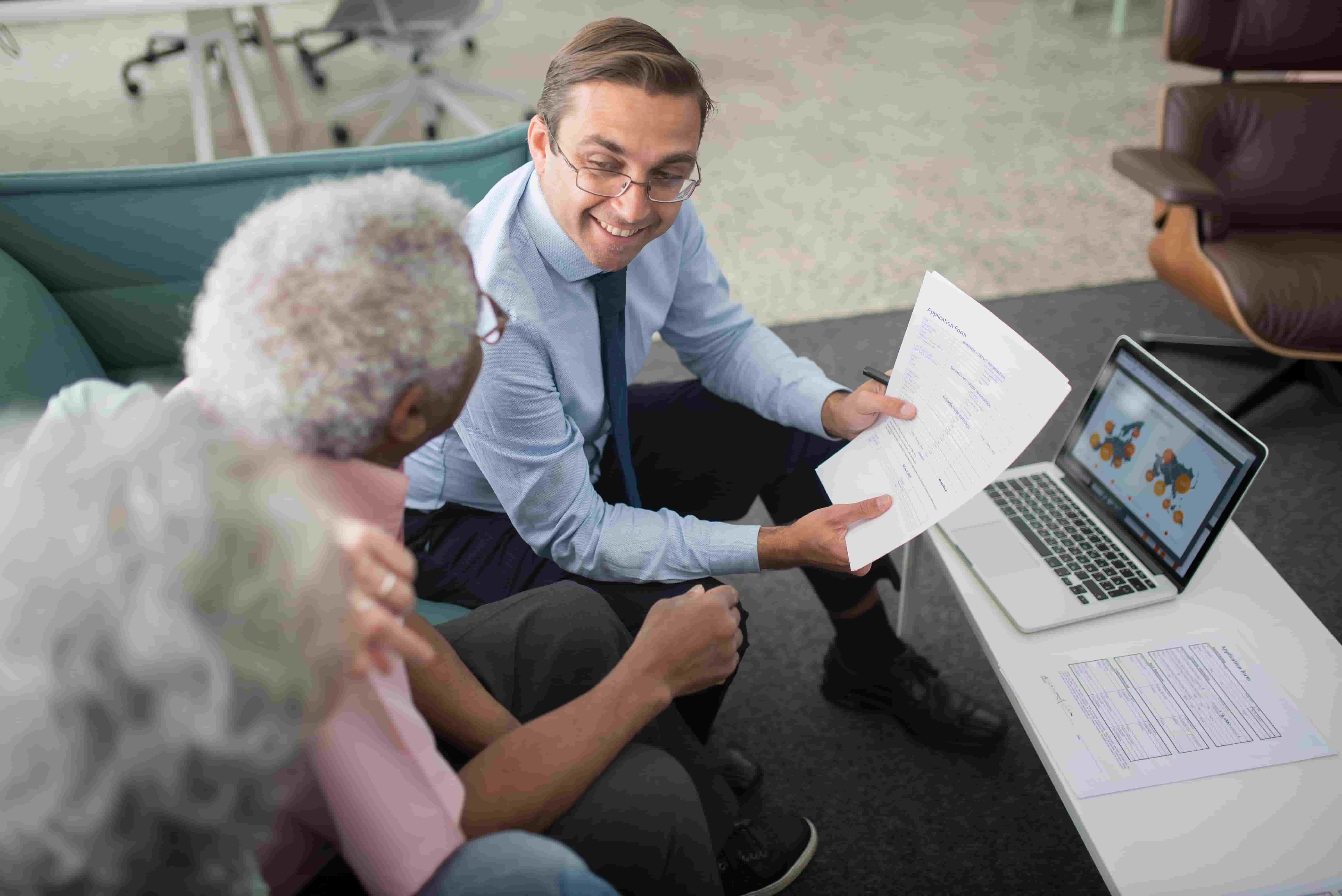 Insurance agent reviewing an application form with a client